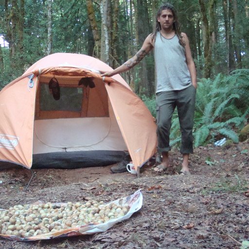 Tate in front of his tent with hazle;nuts